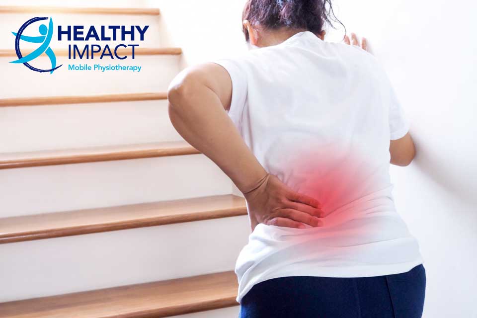 Sciatica article image of a woman with back pain going upstairs